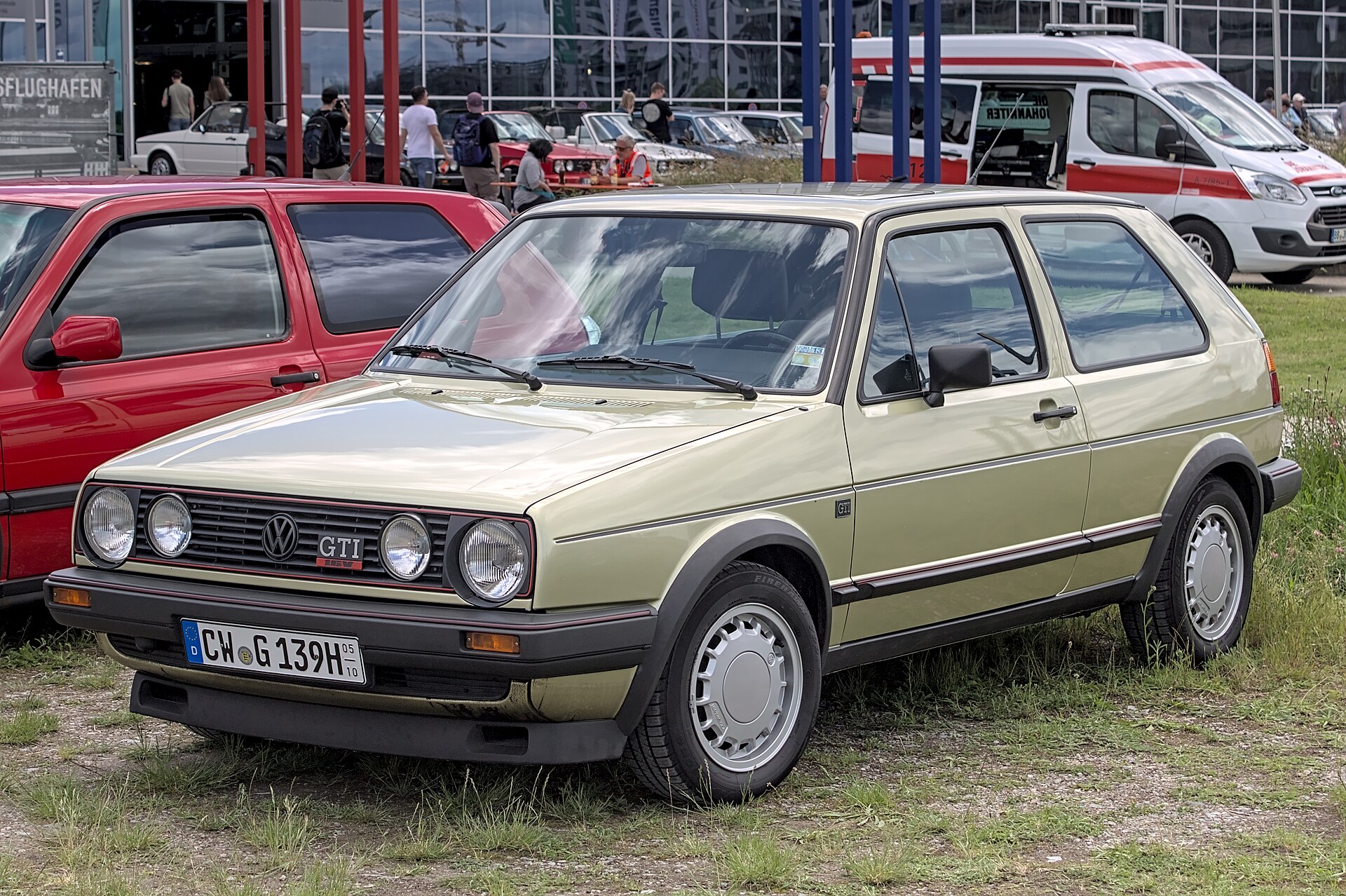 Beigefarbener VW Golf 2 GTI 16V mit Doppelscheinwerfer-Front und GTI-Schriftzug am Grill